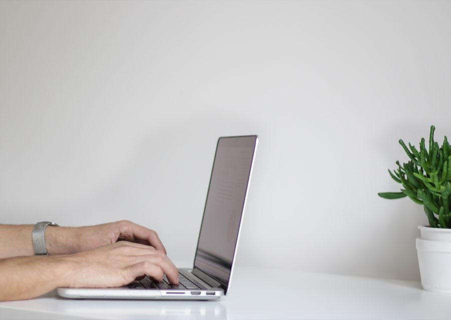 A specialist working on a client project at a laptop